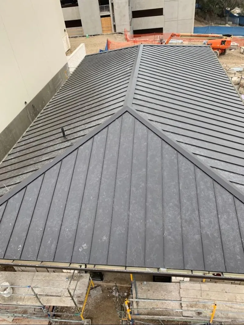 Commercial metal roof construction with crane equipment in New Albany